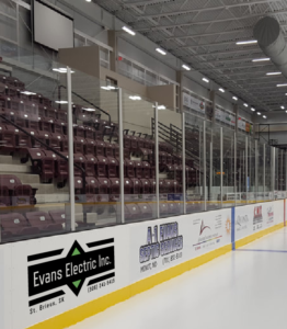 Evans Electric Inc Rink Board Mockup A mockup picture of what Evans Electric Inc logo would look like when placed on the local hockey rink boards